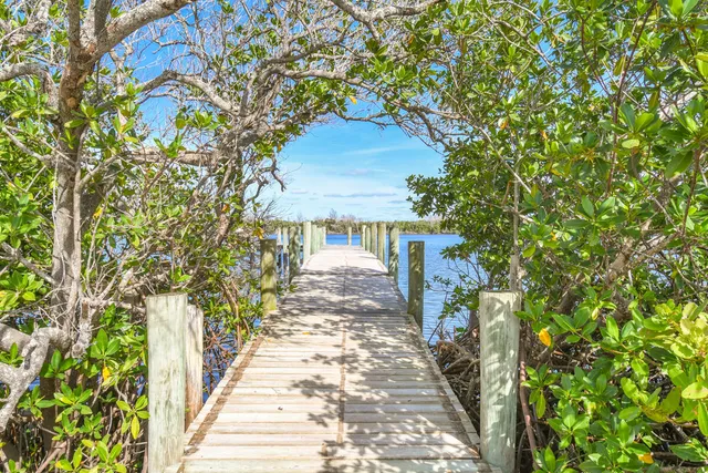 a pathway of a house with a yard