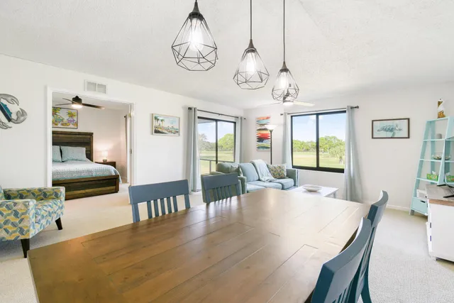 a dining room with furniture and a chandelier