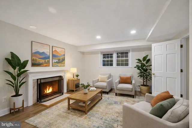 a living room with furniture a window and a fireplace