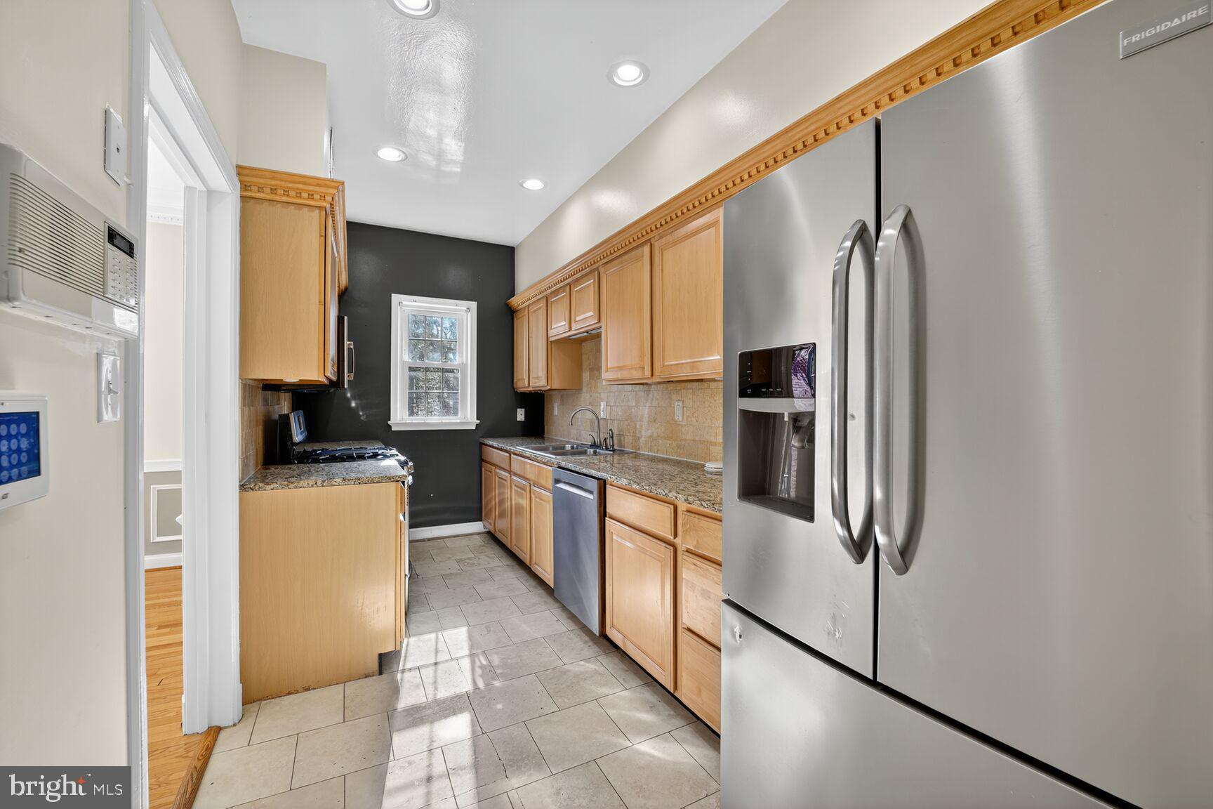 4200 River Road Northwest Washington, DC 20016 - Photo 22 of 52 a kitchen with stainless steel appliances granite countertop a refrigerator and a stove