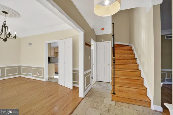 a view of a hallway with front door and wooden floor