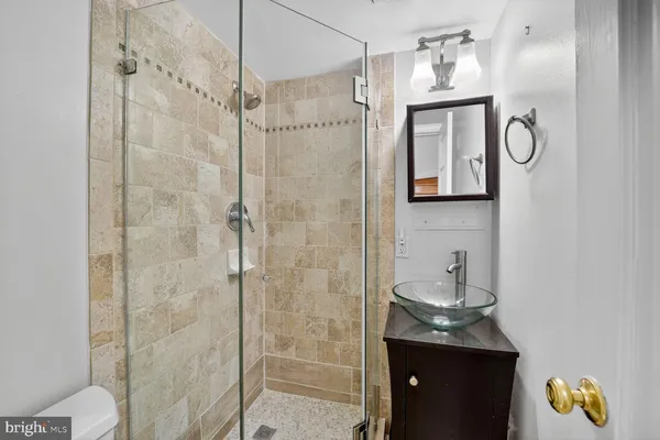 a bathroom with a toilet a sink and shower