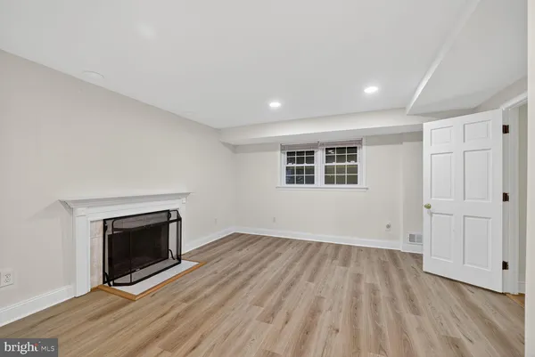 wooden floor in an empty room with a fireplace