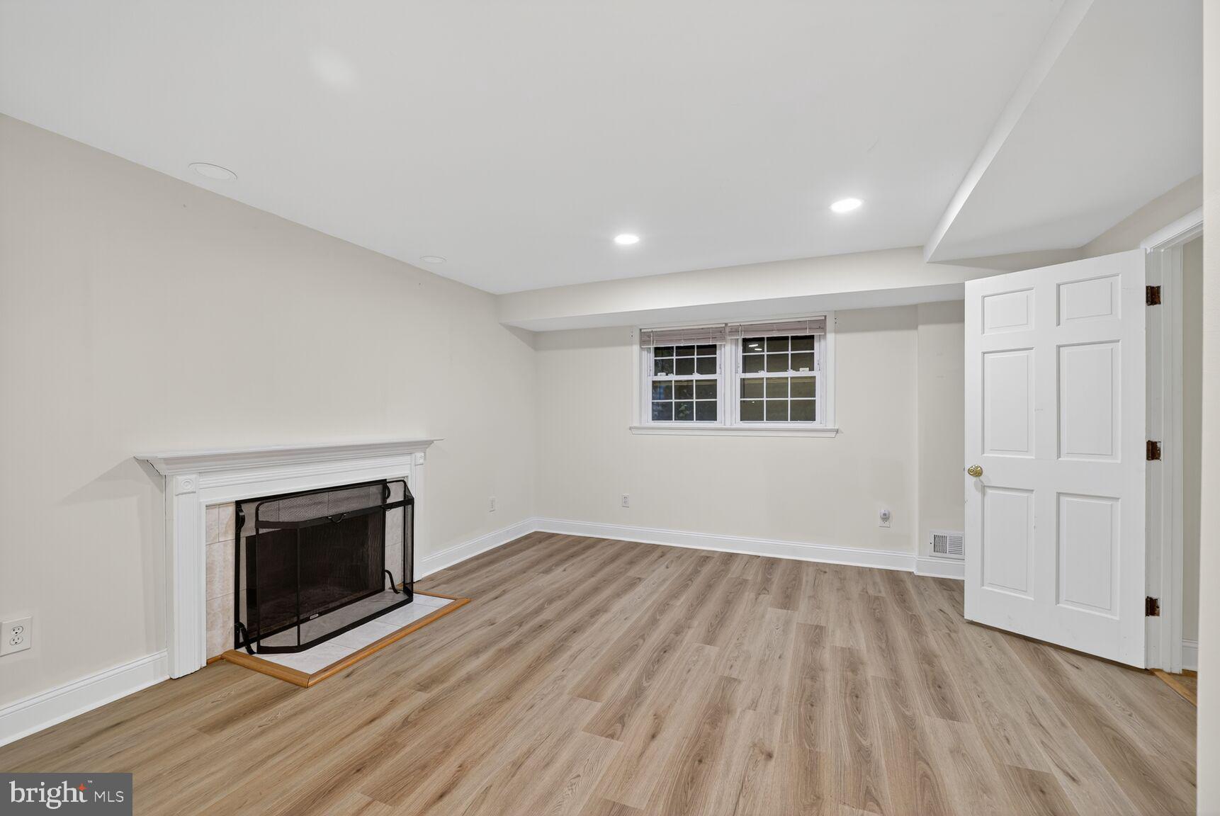4200 River Road Northwest Washington, DC 20016 - Photo 36 of 52 wooden floor in an empty room with a fireplace
