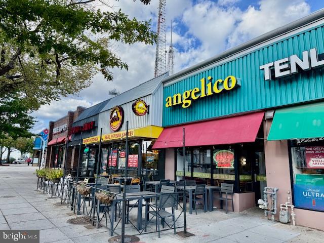 4200 River Road Northwest Washington, DC 20016 - Photo 42 of 52 a view of a cafe with a table and chairs under an umbrella