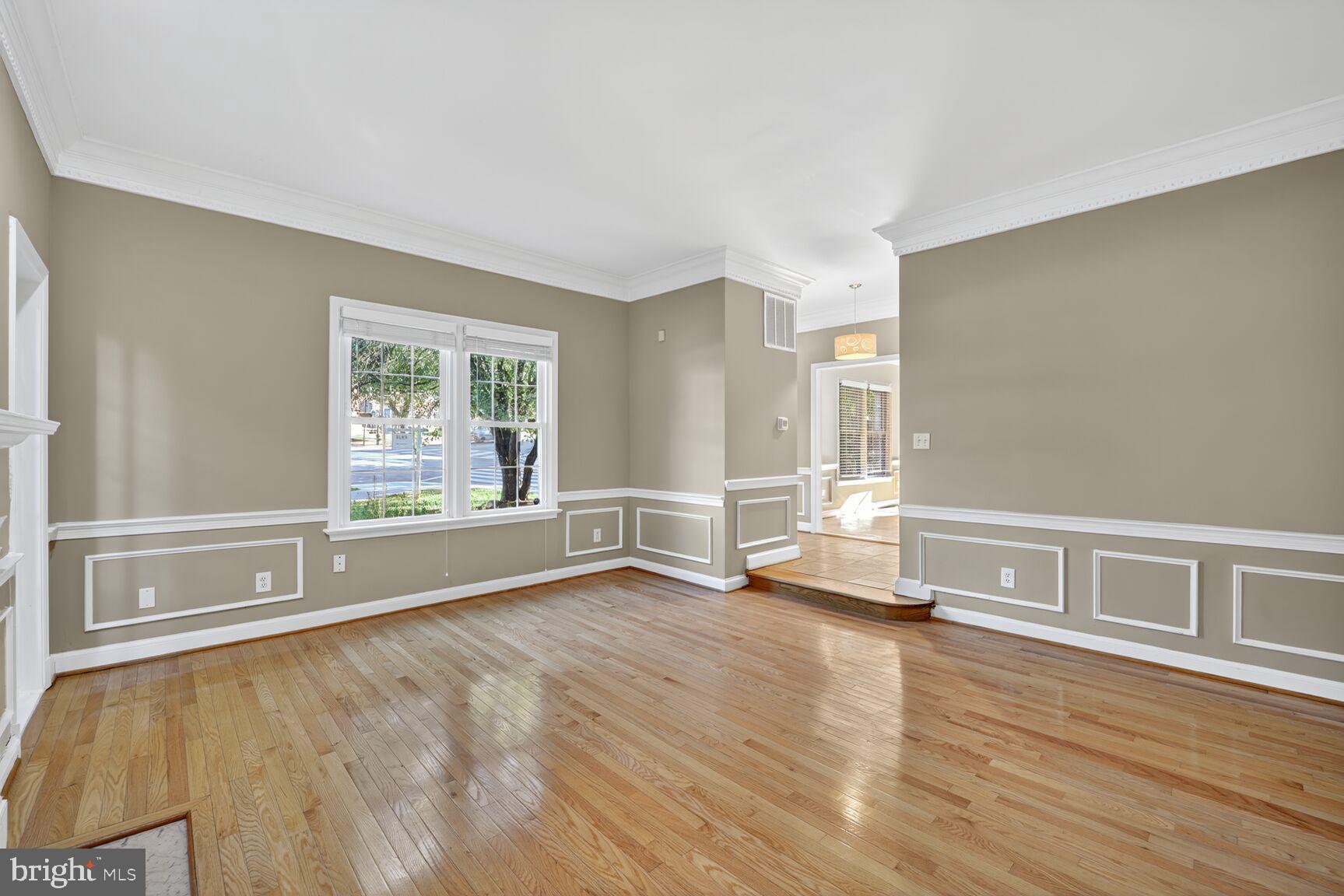 4200 River Road Northwest Washington, DC 20016 - Photo 5 of 40 an empty room with wooden floor and windows