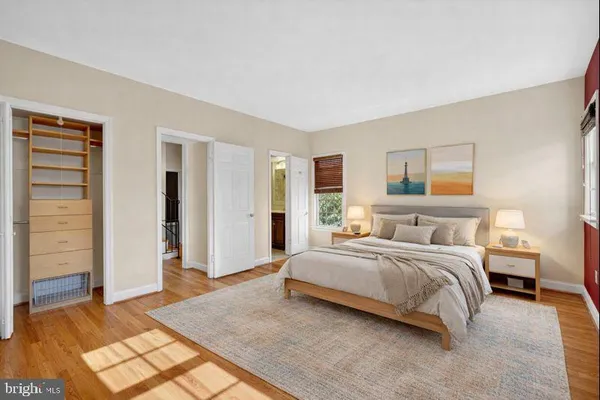 a spacious bedroom with a bed and a couch