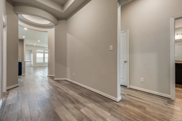 a view of a hallway with wooden floor
