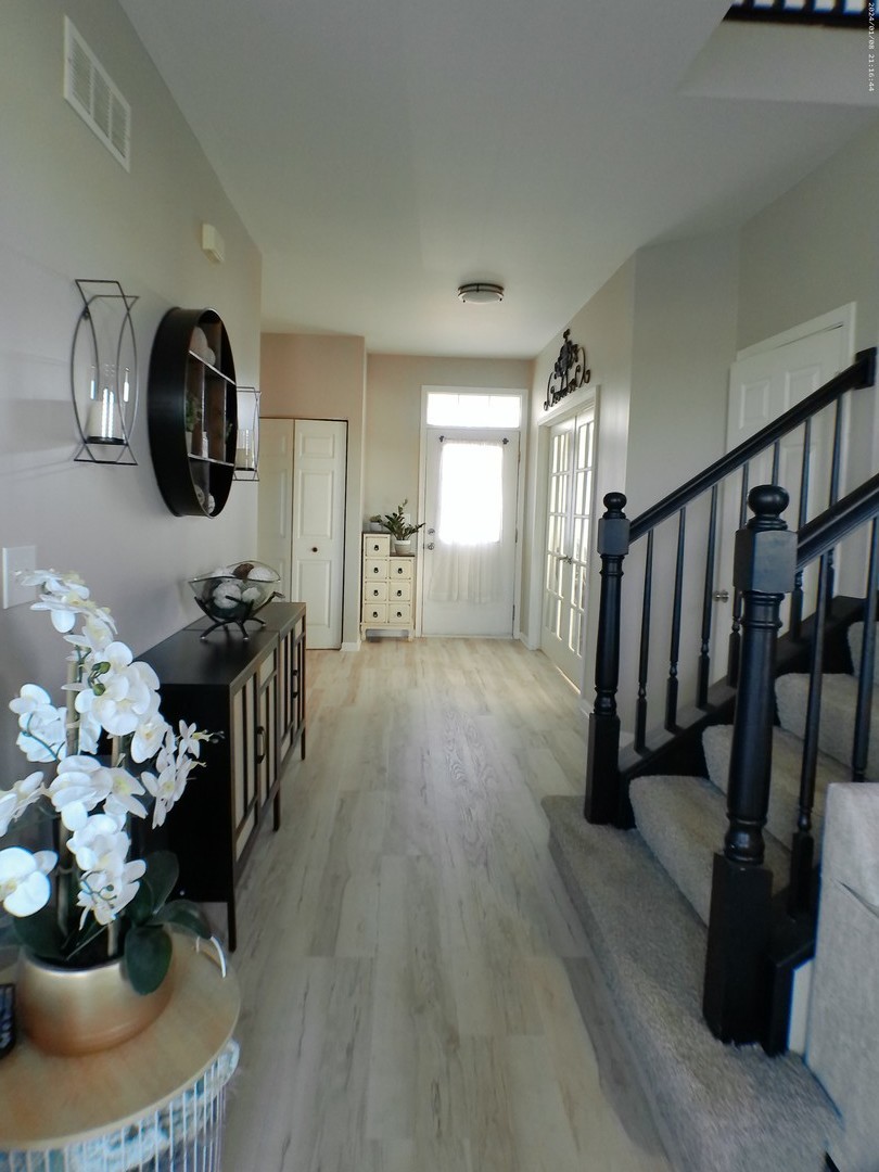 1404 Roth Drive Joliet, IL 60431 - Photo 2 of 52 a hallway with wooden floor