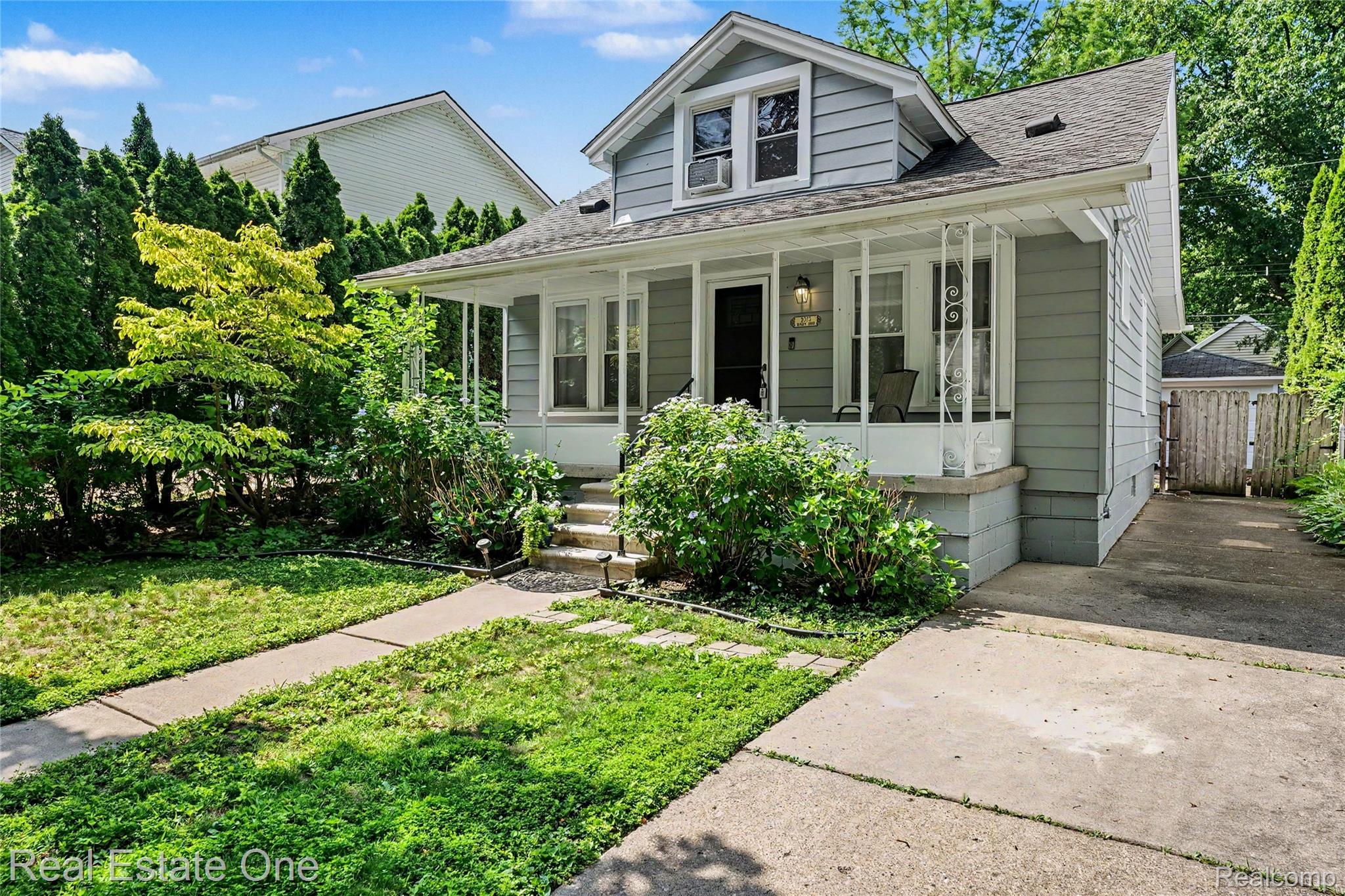 2073 Roslyn Road Grosse Pointe, MI 48236 - Photo 2 of 30 Light gray exterior with white trim, featuring a covered front porch with white pillars