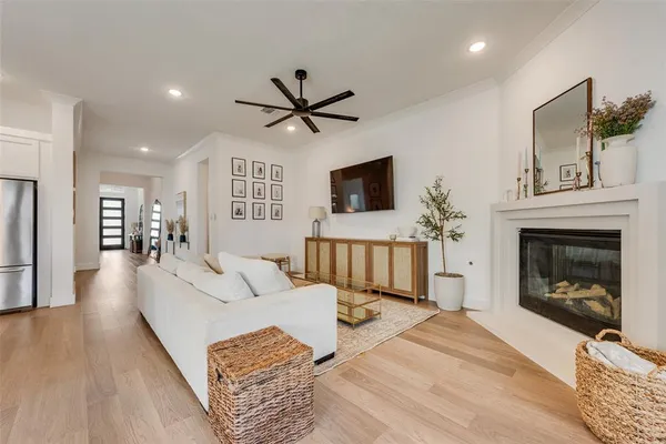 a living room with furniture a fireplace and a flat screen tv