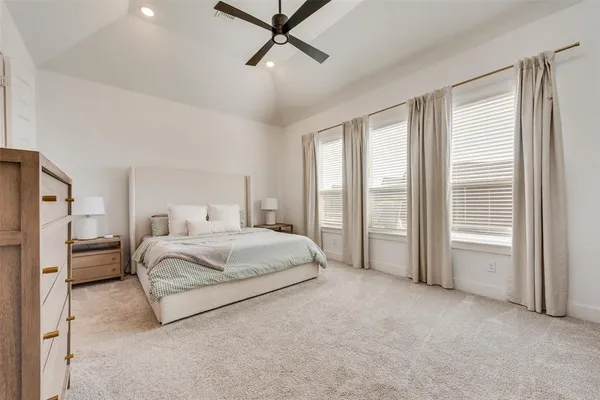 a spacious bedroom with a bed and a window