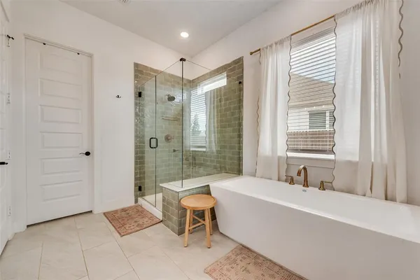 a spacious bathroom with a bathtub and shower