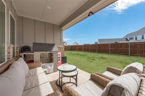 a view of a patio with a yard