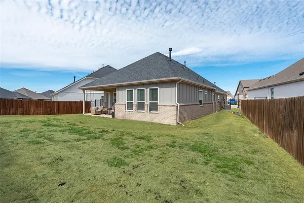 a view of a house with a yard and sitting area