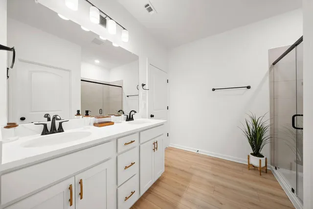 a bathroom with a double vanity sink and a mirror