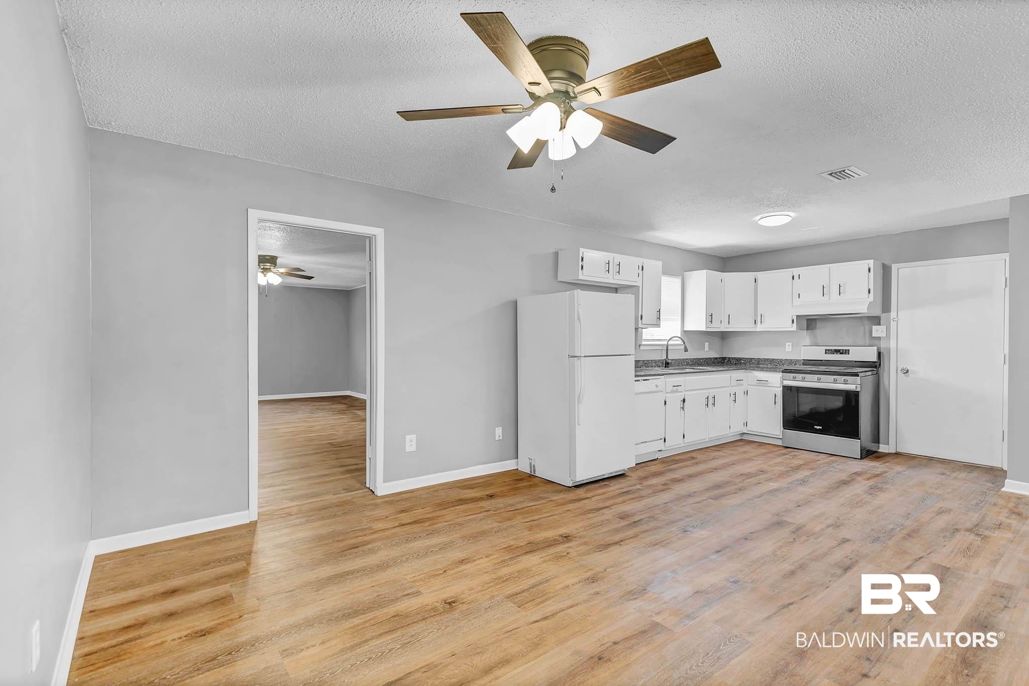 3304 Armond Drive Mobile, AL 36605 - Photo 14 of 62 Kitchen featuring white appliances, a ceiling fan, a textured ceiling, and light wood finished floors