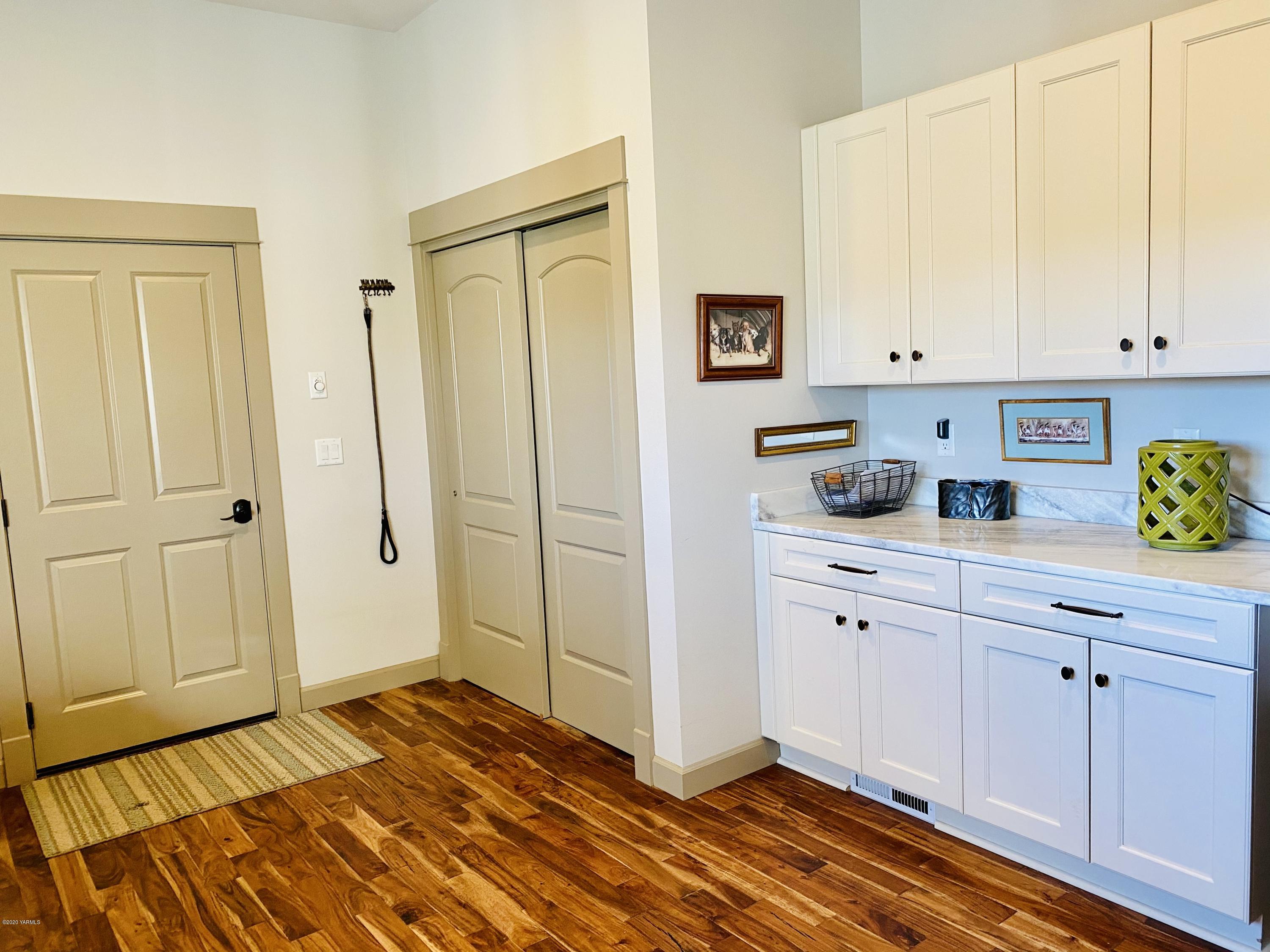 1401 Beaudry Road Yakima, WA 98901 - Photo 22 of 39 a kitchen with white cabinets and wooden floor