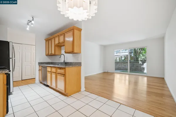 a view of kitchen with granite countertop cabinets and outdoor space