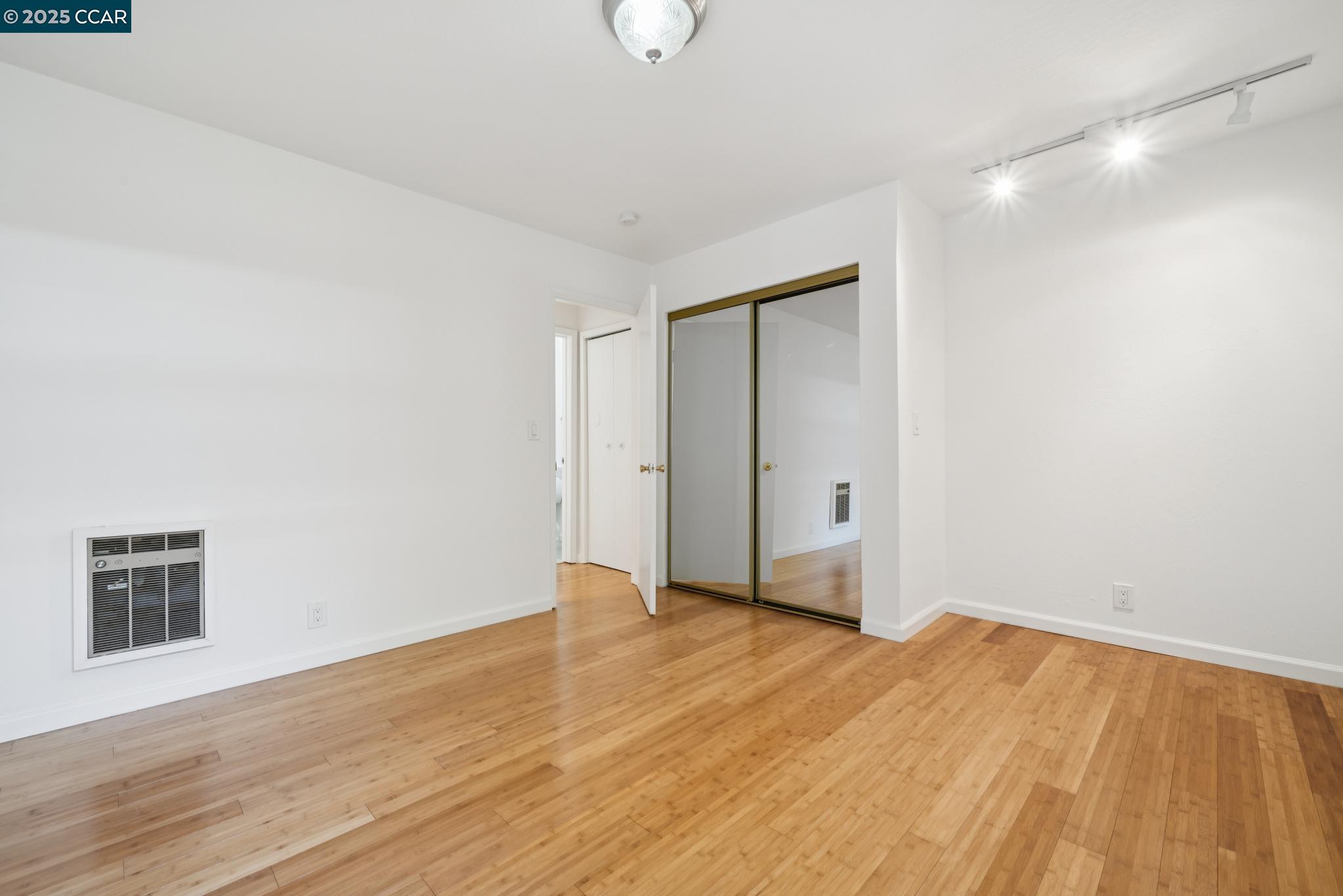 150 Pearl Street, Unit 122 Oakland, CA 94611 - Photo 12 of 34 a view of an empty room with wooden floor