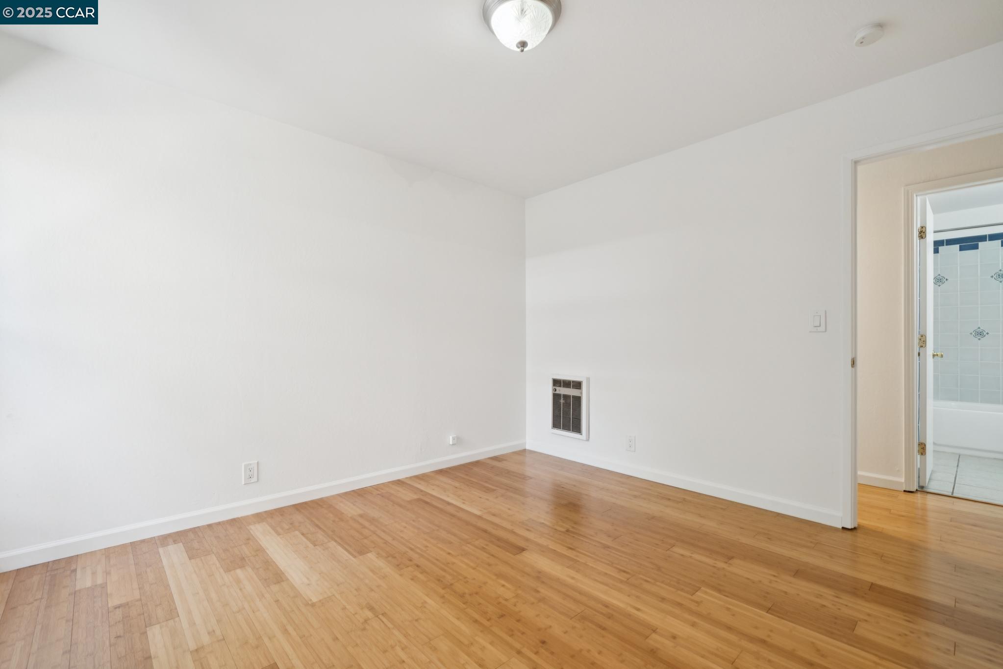 150 Pearl Street, Unit 122 Oakland, CA 94611 - Photo 14 of 34 a view of an empty room with wooden floor