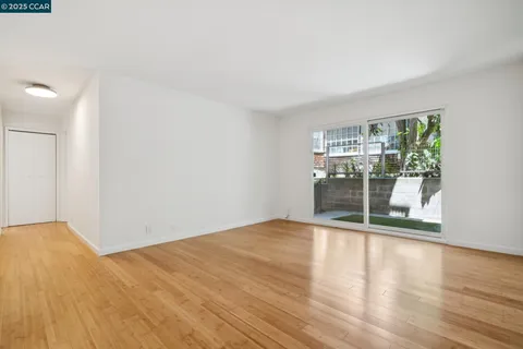a view of wooden floor and windows in a room