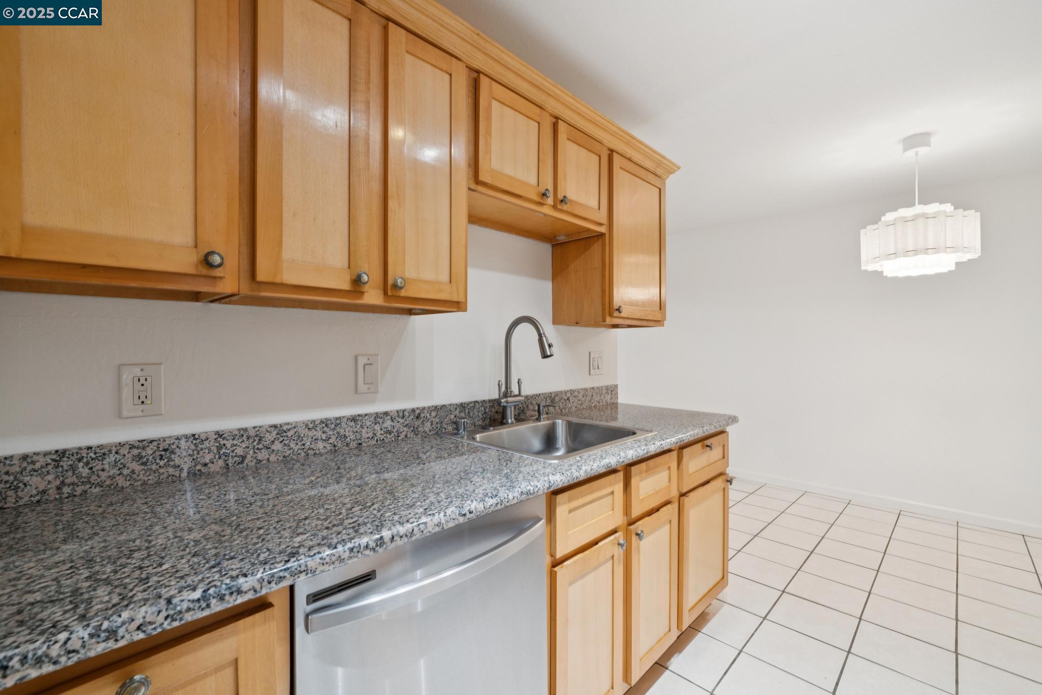 150 Pearl Street, Unit 122 Oakland, CA 94611 - Photo 7 of 34 a kitchen with granite countertop a sink and cabinets