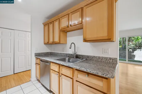 a kitchen with granite countertop a sink and cabinets