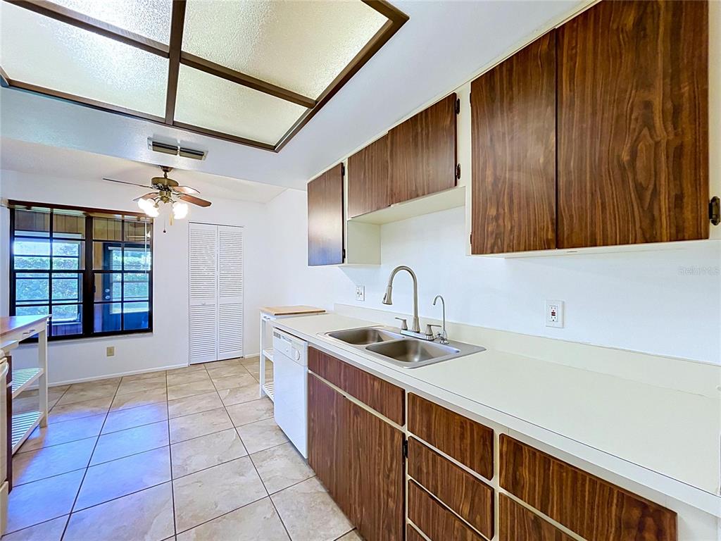 9319 Trowbridge Court New Port Richey, FL 34655 - Photo 28 of 78 a kitchen with stainless steel appliances granite countertop a sink and cabinets
