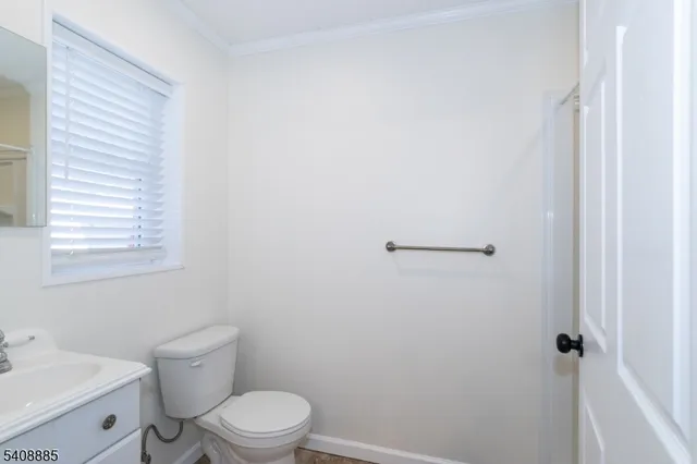 a white toilet sitting next to a bathroom sink