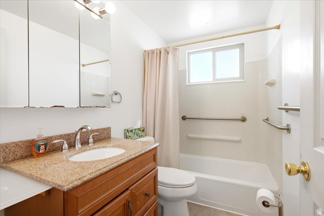 7050 South 260 East Midvale, UT 84047 - Photo 17 of 28 Bathroom featuring a single vanity with a granite-style countertop, an undermount sink, and chrome fixtures