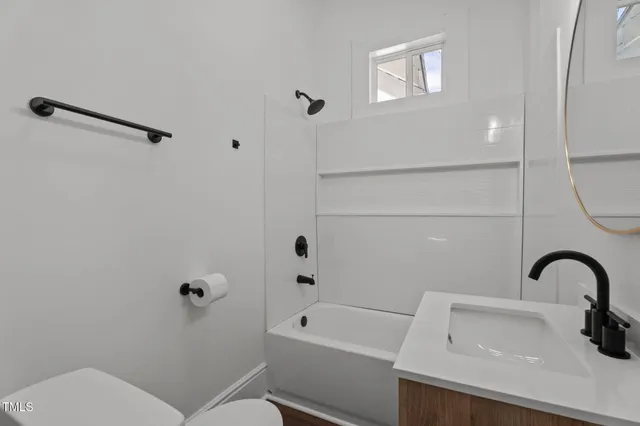a view of a bathroom with a sink and mirror