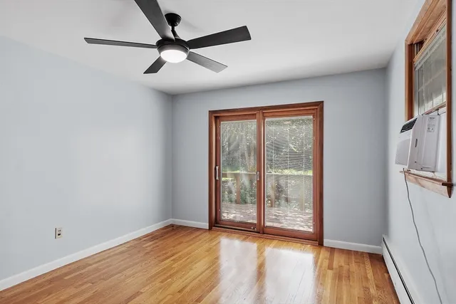 a view of room with window and wooden floor