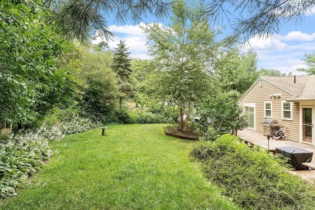 a view of a house with a yard and sitting area