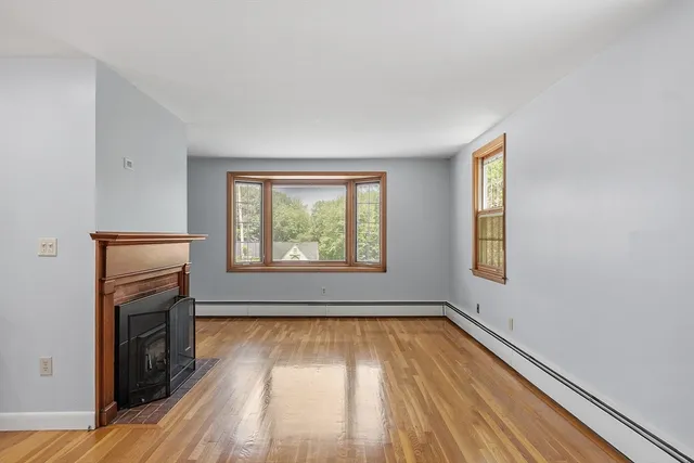 wooden floor in an empty room with a window