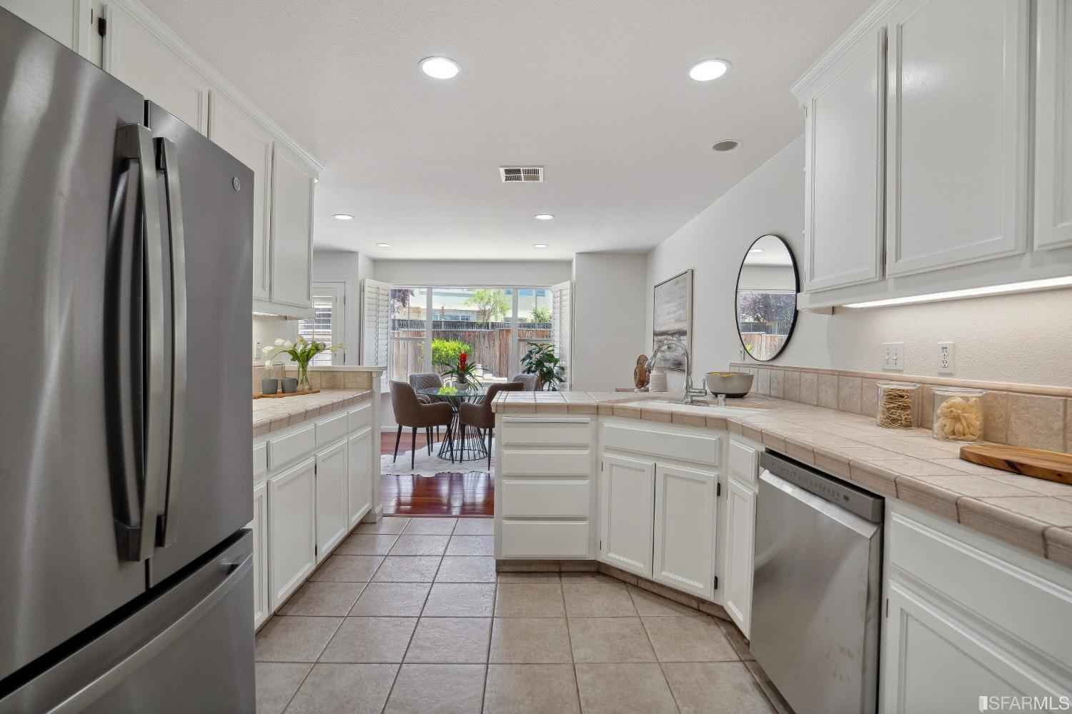 7531 Imperata Lane San Ramon, CA 94582 - Photo 17 of 37 a kitchen with white cabinets and appliances