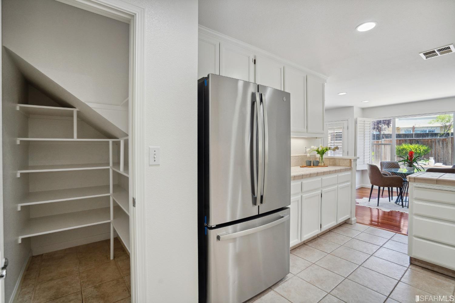 7531 Imperata Lane San Ramon, CA 94582 - Photo 18 of 37 a kitchen with white cabinets and refrigerator