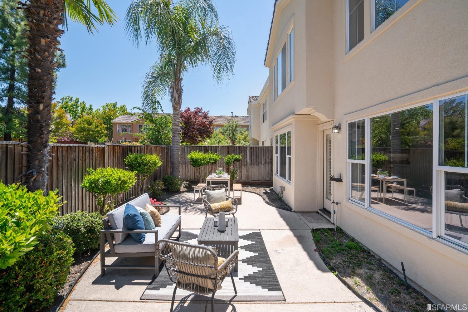 7531 Imperata Lane San Ramon, CA 94582 - Photo 27 of 37 a view of a patio with couches table and chairs potted plants and palm tree