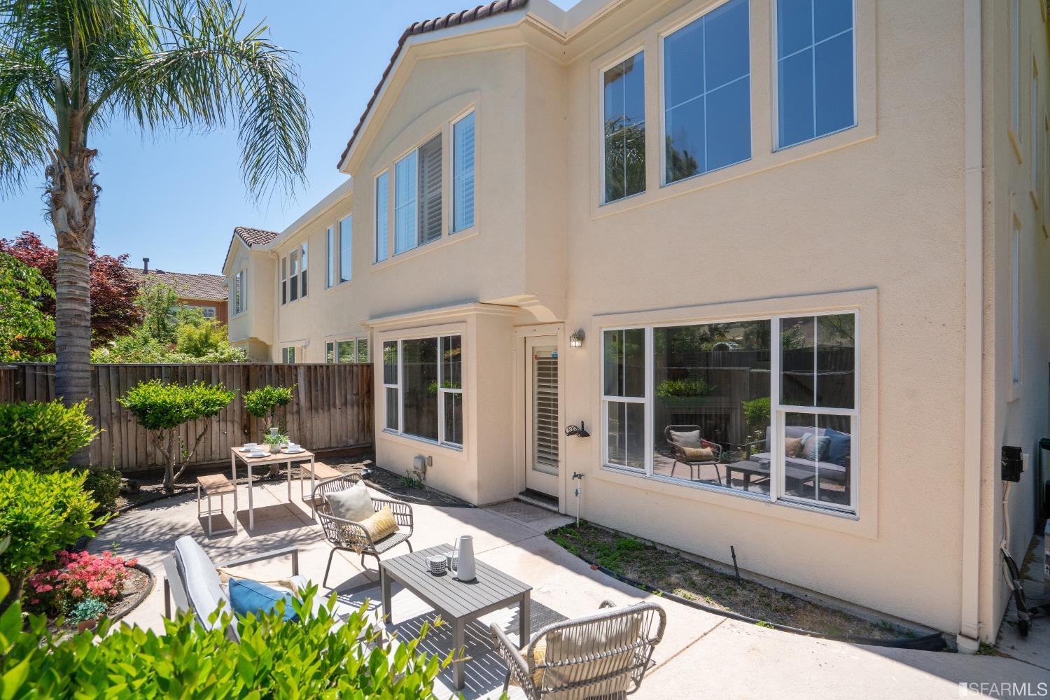 7531 Imperata Lane San Ramon, CA 94582 - Photo 28 of 37 a view of a patio with table and chairs potted plants and floor to ceiling window