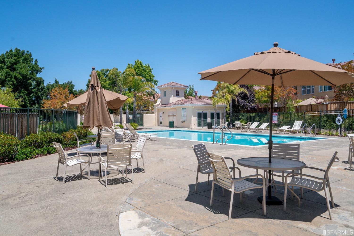 7531 Imperata Lane San Ramon, CA 94582 - Photo 34 of 37 a patio with a table and chairs under an umbrella