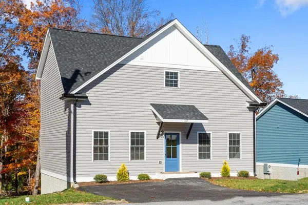 a view of a house with a yard and garage