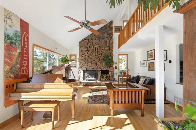 a living room with fireplace furniture and a floor to ceiling window