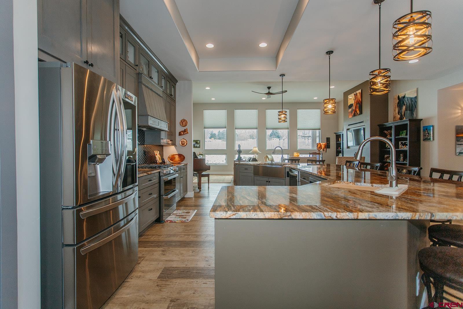 4041 Pioneer Road Montrose, CO 81403 - Photo 11 of 43 a kitchen with stainless steel appliances granite countertop a refrigerator and a sink