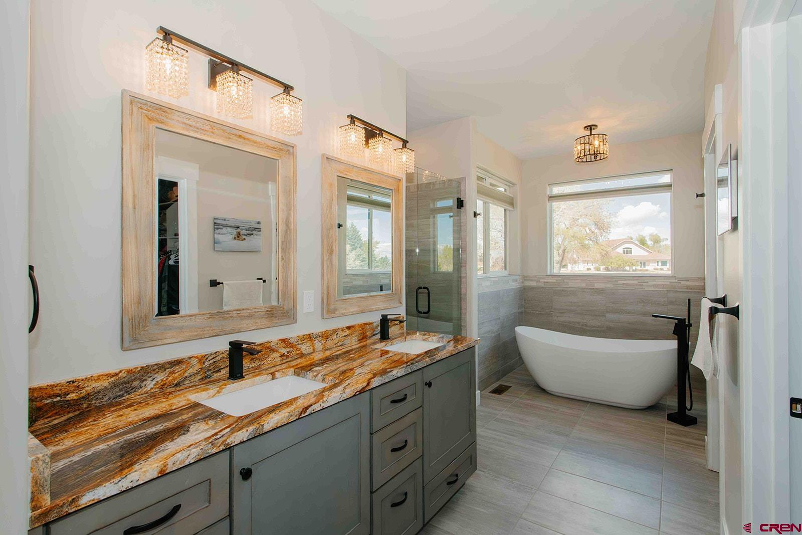 4041 Pioneer Road Montrose, CO 81403 - Photo 14 of 43 a bathroom with a granite countertop sink and a mirror