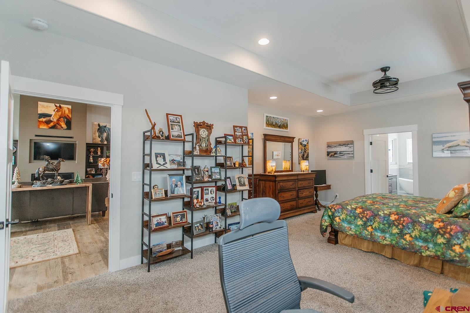 4041 Pioneer Road Montrose, CO 81403 - Photo 15 of 43 a bedroom with furniture and a book shelf
