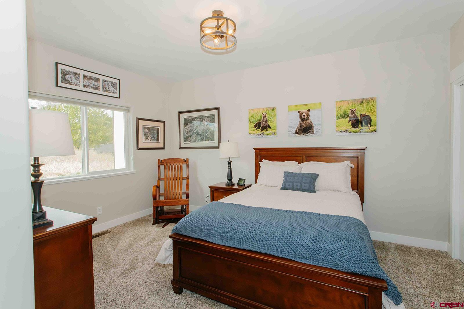 4041 Pioneer Road Montrose, CO 81403 - Photo 17 of 43 a bedroom with a bed and a dresser next to it