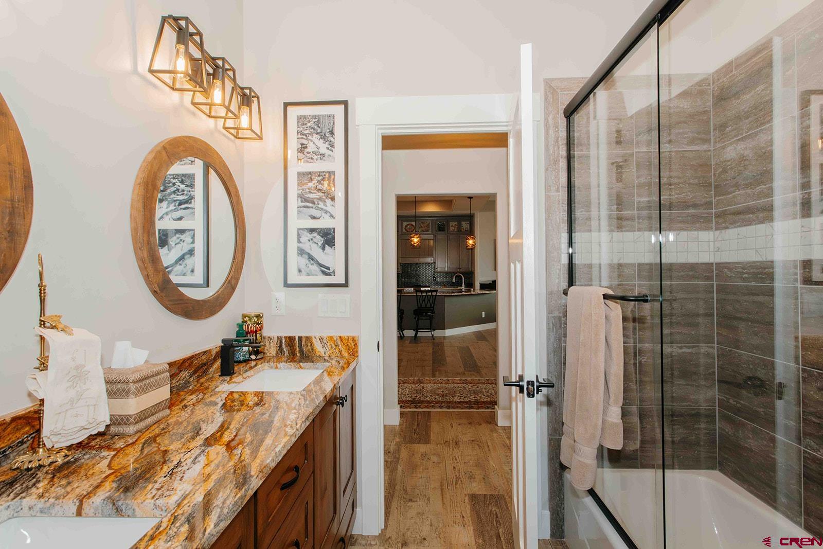 4041 Pioneer Road Montrose, CO 81403 - Photo 19 of 43 a bathroom with a double vanity sink and a mirror