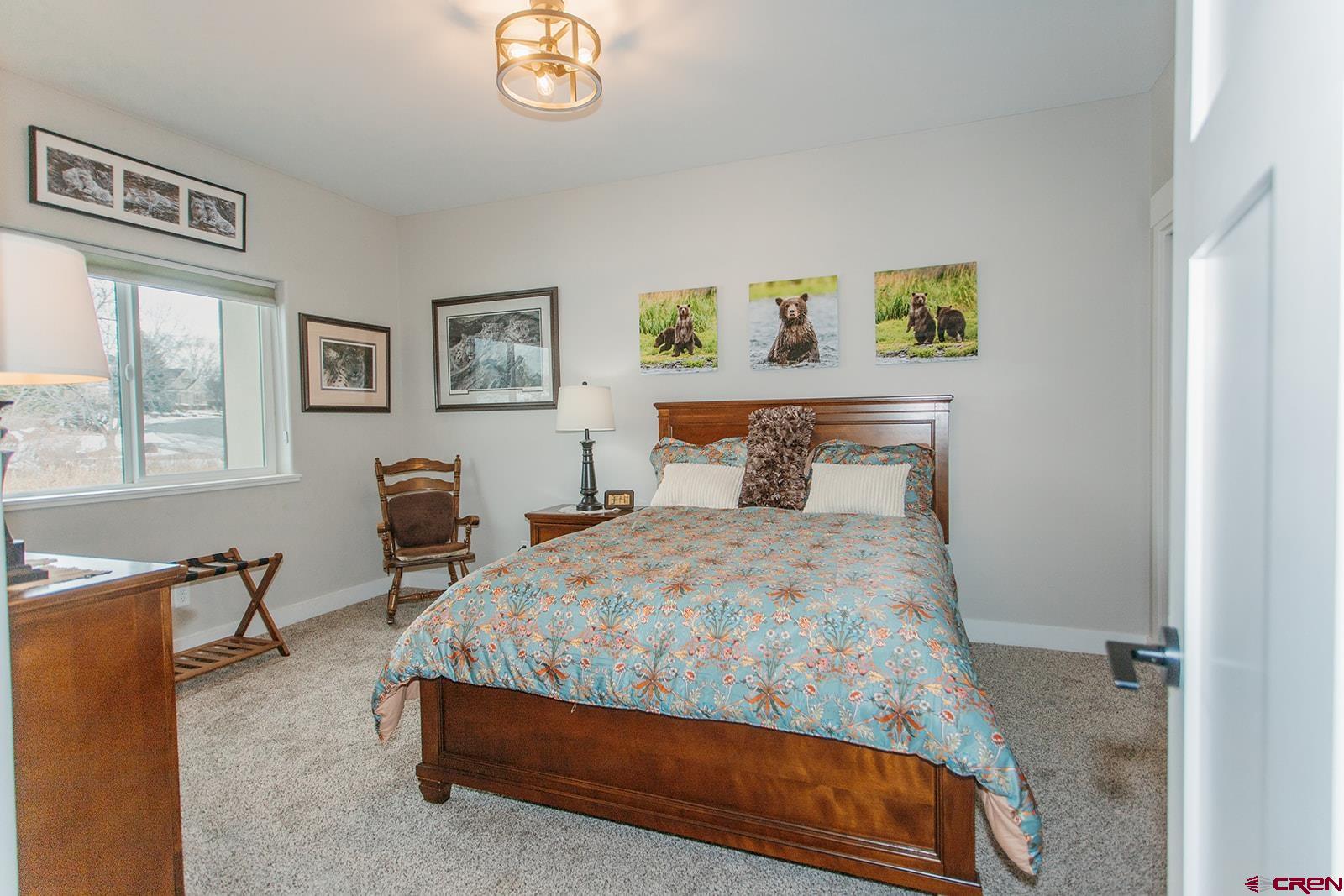 4041 Pioneer Road Montrose, CO 81403 - Photo 19 of 43 a bedroom with a bed a table and chair