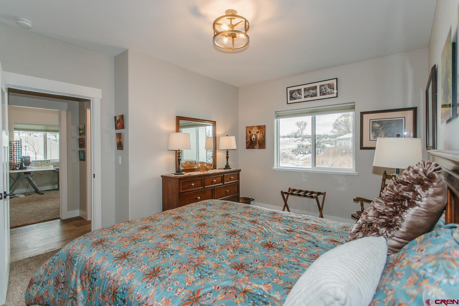 4041 Pioneer Road Montrose, CO 81403 - Photo 20 of 43 a bedroom with a bed and a dresser in it