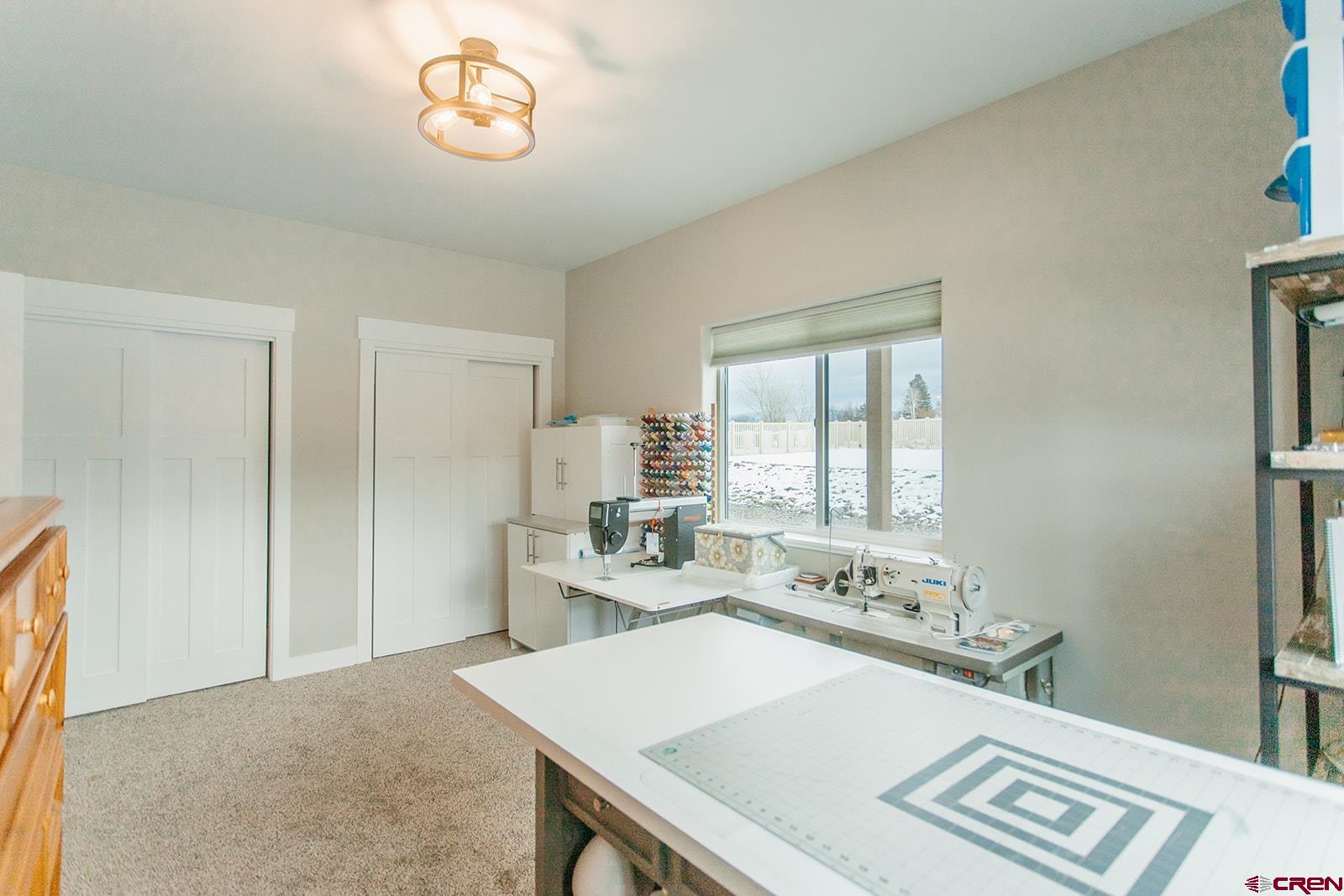 4041 Pioneer Road Montrose, CO 81403 - Photo 22 of 43 a view of kitchen island a sink and a refrigerator